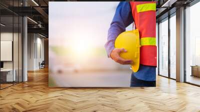 Engineer holding hard hat construction worker professional safety work industry building person manager service Wall mural