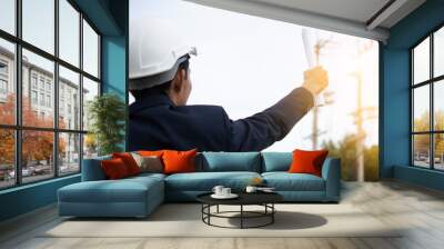 Engineer Holding paper plan and Sky Background Wall mural