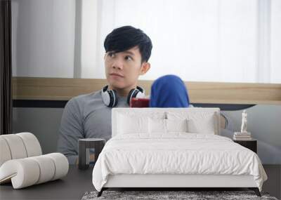 New normal Asian man living in bedroom stay at home social distancing and working on mobile internet,Mobile smartphone device network touchscreen freelancer technology communication Wall mural