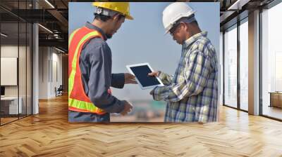 Two Engineering using tablet technology checking inspection work construction and talking planing project management Wall mural