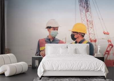 Two people Engineer work on site construction wear face mask protect PM2.5 and Corona virus covid 19 Wall mural