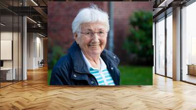 Portrait of very old happy senior woman with white hair outdoors Wall mural