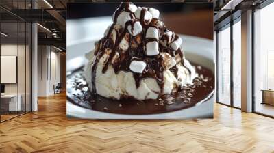 A scoop of vanilla ice cream topped with a generous amount of marshmallows, covered in chocolate sauce and chocolate shavings on a white plate. Wall mural