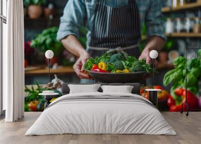 Chef presents a bowl of fresh vegetables in a rustic kitchen, showcasing organic ingredients for healthy cooking, Concept of culinary arts and sustainable eating Wall mural