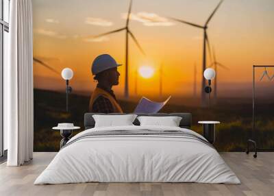 Engineer inspecting wind farm at sunset, Concept of renewable energy, sustainability, and environmental engineering Wall mural