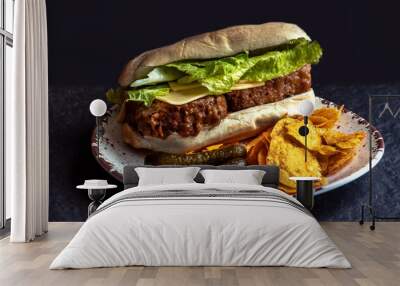 meatloaf sandwich  on a hoagie roll with pickles and chieese and lettuce, and chips Wall mural