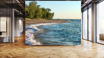 Deserted beach with lifeguard chairs and trees in background on Presque Isle on Lake Erie Wall mural