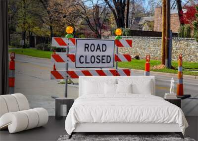 Road closed sign in the middle of four lane highway in residential neighborhood in early spring Wall mural