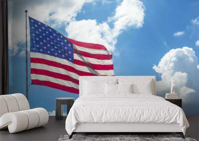 Waving American flag against a bright blue sky with fluffy white clouds Wall mural