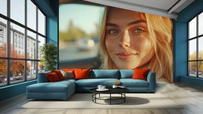 closeup of the beautiful young woman with blond hair driving a car on the road, sitting in the automobile interior, looking at the camera and smiling. vehicle travel and transport, summer trip Wall mural