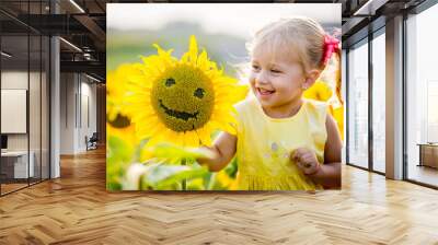 beautiful little girl in sunflowers Wall mural