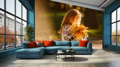 Beautiful red head girl holding autumn leaves and posing for camera, colorful photo Wall mural