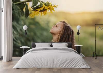 Child and sunflower, summer, nature and fun. Summer holiday. Wall mural