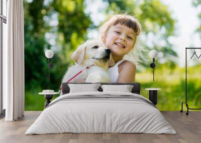 Little girl with a Golden retriever puppy Wall mural