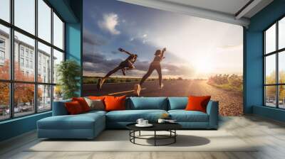 Young couples running sprinting at sunset times. Fit runner fitness runner during outdoor workout. Wall mural