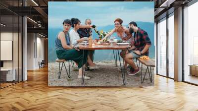 Friends and family gathered for picnic dinner for Thanksgiving. Festive young people celebrating life with red wine, grapes, cheese platter, and a selection of cold meats Wall mural