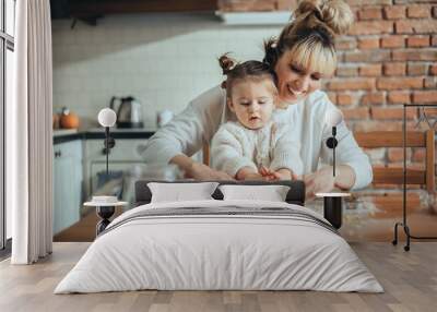 Mother and daughter baking cookies in their kitchen Wall mural