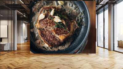 Overhead shot of chef preparing ribeye with butter, thyme and garlic. Keto diet. Wall mural