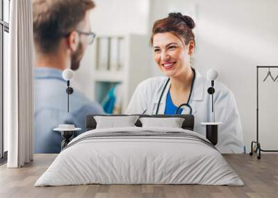 Woman Doctor talking to Patient at her Medical Office Wall mural