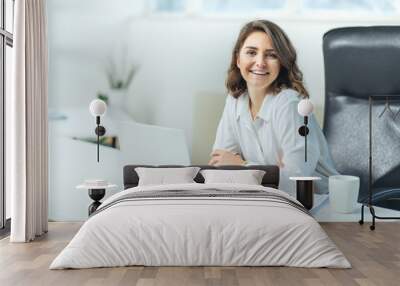 Young woman in office working Wall mural