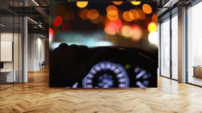 black steering wheel inside car drive in night city street Wall mural