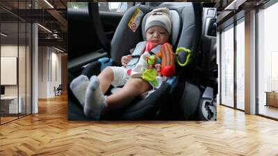 cute baby boy sitting on car seat safety belt lock protection for drive road trip Wall mural