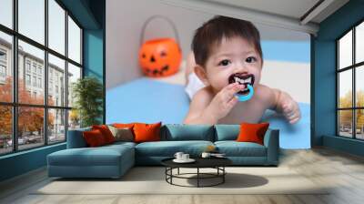 little kid baby sucking nipple pacifier teeth vampire dracula devil, costume of halloween celebration party Wall mural