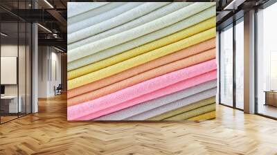 stack of colourful cotton clothes, close up pile of clothing Wall mural