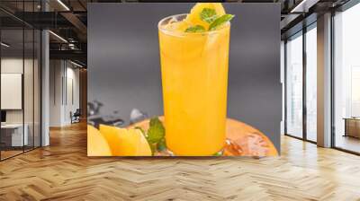 Fresh orange juice in glass with mint, fresh fruits. selective focus. Wall mural