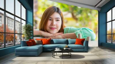 Asian female look happily with her money saving Wall mural