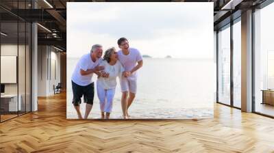 Happy family walking relax on the beach. Wall mural