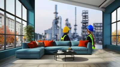 Smart two female engineer discussion together at refinery industry plant at industry factory center area. Engineering Concept Wall mural