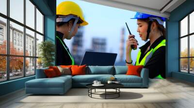 Smart two female engineer discussion together at refinery industry plant at industry factory center area. Engineering Concept Wall mural