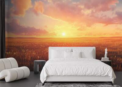 A peaceful sunset over a wide, flat grassland, with warm orange and pink hues reflecting off the sky and casting long shadows across the field. Wall mural