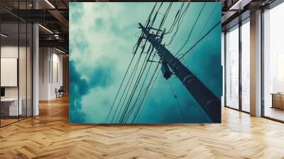 A perspective shot looking up at an electric pole, with power lines fanning out into the sky, creating a sense of height and structure. Wall mural