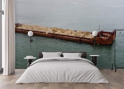 A large barge with soil floats into the sea top view Wall mural