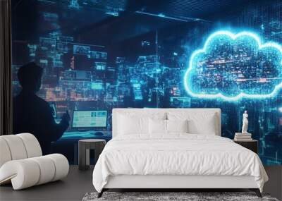 A person works on a laptop in a futuristic environment with data and cloud computing graphics, representing digital transformation and technology. Wall mural