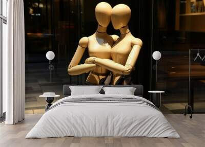 Two wooden drawing mannequins embracing each other in a heartfelt hug, symbolizing connection, warmth, and emotional support in human relationships, showcasing affection, closeness, and mutual care Wall mural