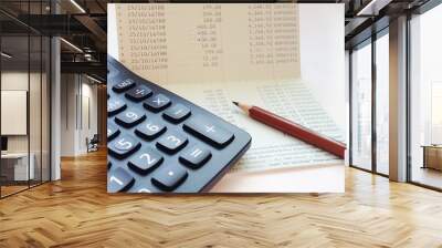 Business, finance, investment or accounting concept : Calculator and saving account book or financial statement on office table Wall mural