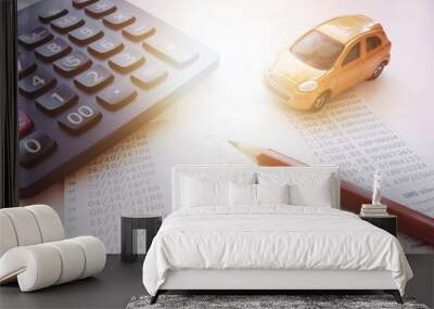 Business, finance, saving money, banking or car loan concept : Miniature car model, calculator and saving account book or financial statement on office desk table Wall mural