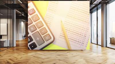 Business or finance background concept : Calculator, pencil and savings account passbook on yellow background Wall mural