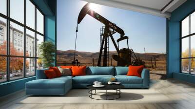 Oil drilling derricks at desert oilfield. Crude oil production from the ground. Oilfield services contractor. Oil drill rig and pump jack. Petroleum production, natural gas, liquids, NGL, additive. Wall mural