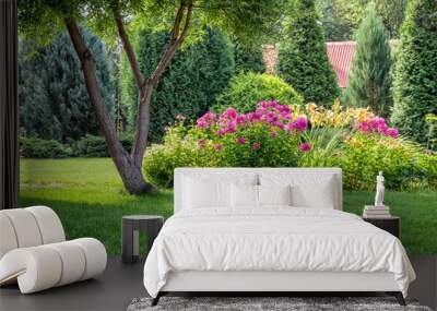 A beautiful flower bed in the backyard of a private house. Wall mural