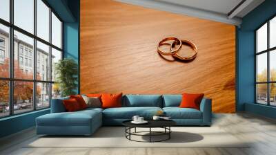 Golden rings lie on a wooden table Wall mural