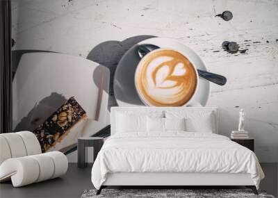 Top view of cappuccino and snack on white table Wall mural