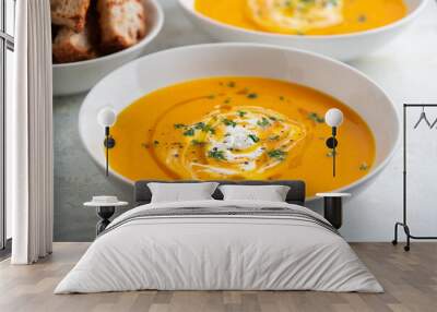 Pumpkin soup served in a bowl with croutons, parsley and olive oil. Wall mural