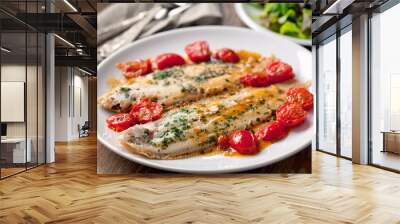 Sole with cherry tomatoes on a plate. High quality photo. Wall mural