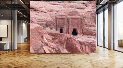 The man-made caves carved in red mountain in Petra - the capital of the Nabatean kingdom in Wadi Musa city in Jordan Wall mural