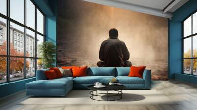 A man sitting in the ground facing a hill and watching the sunrise in a moment of peace Generative AI Illustration Wall mural