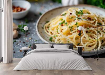 A close-up view of Spaghetti Aglio e Olio, beautifully garnished with fresh herbs and sprinkled with spices, presented in a sleek, modern dining setting. Wall mural